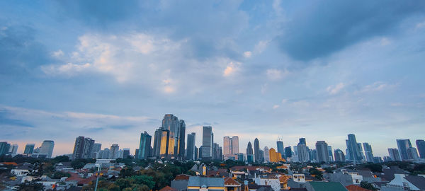 Panoramic view of modern buildings in city against sky