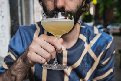 Close-up of man drinking beer glass