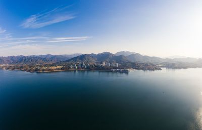 Scenic view of lake and mountains against blue sky