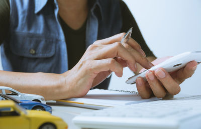 Midsection of man working on table