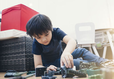 Rear view of boy looking at camera