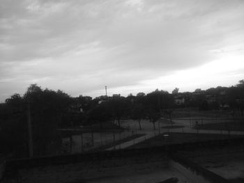 View of town against cloudy sky