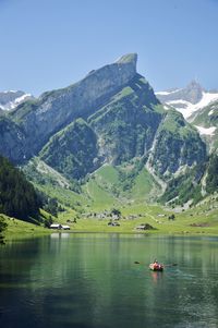 Scenic view of lake and mountains against sky