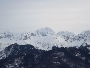 Scenic view of snowcapped mountains against clear sky