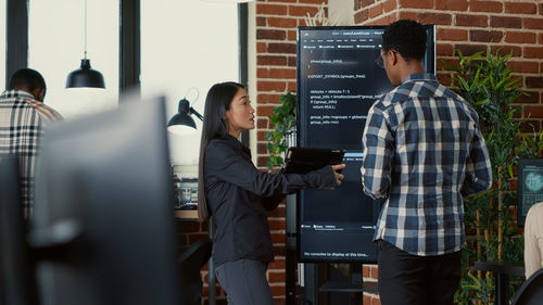 Rear view of business colleagues working in office