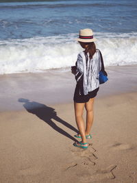 Full length of woman standing on beach