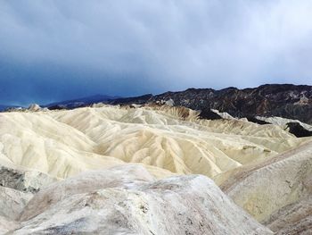 Scenic view of sand dunes against sky