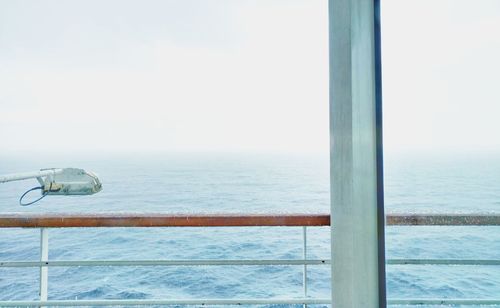 Close-up of boat sailing on sea against clear sky