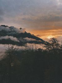 Scenic view of silhouette mountains against sky during sunset