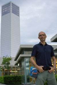 Man standing against modern building