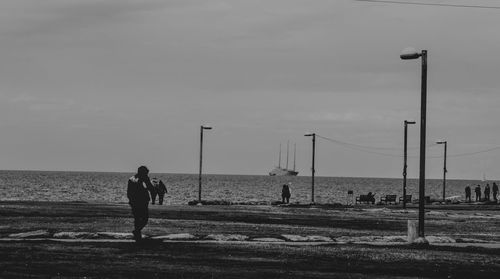 Man standing on beach against sky