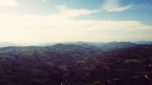 Scenic view of mountains against cloudy sky