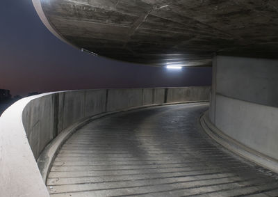 Empty corridor in illuminated building