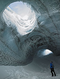Man exploring ice cave in iceland