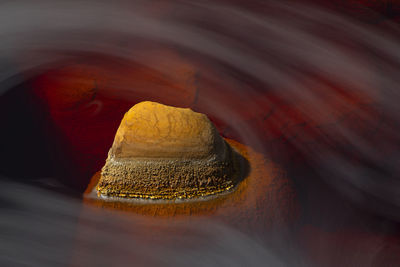 Majestic view of orange rock in river with fast flow in long exposure in minas de rio tinto