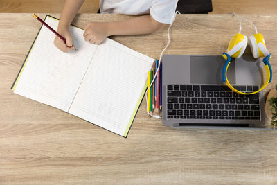 High angle view of man using laptop on table