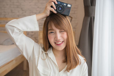 Portrait of happy woman photographing