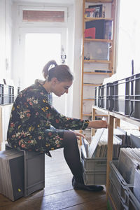 Young woman shopping for records