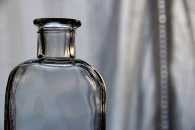 Close-up of empty glass bottle