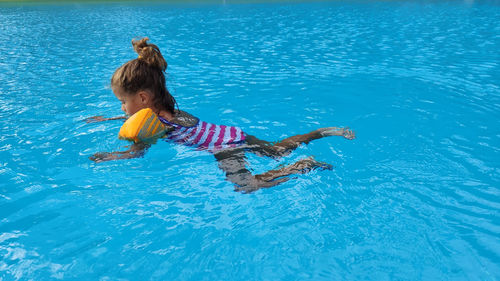 High angle view of girl swimming in pool