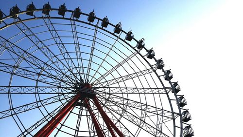 Low angle view of ferris wheel against sky