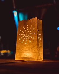 Close-up of illuminated candles on table