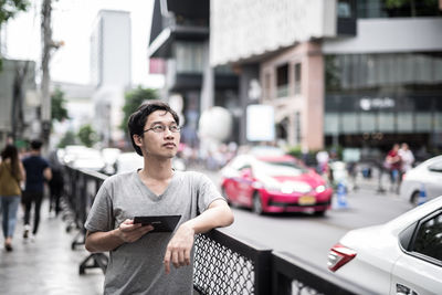 Full length of man using smart phone on street