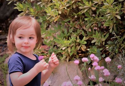 Portrait of cute girl holding flowers