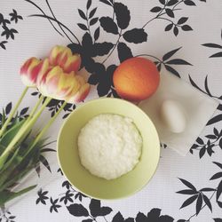 Directly above view of food and fruits with tulips on table