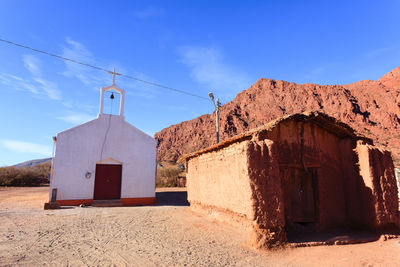 Exterior of old building against blue sky on sunny day