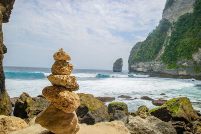 Rocks on beach against sky