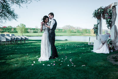 Couple dancing on lawn during wedding ceremony