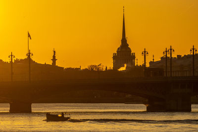 Silhouette of bridge over river against sky during sunset