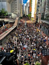 High angle view of people walking on road in city