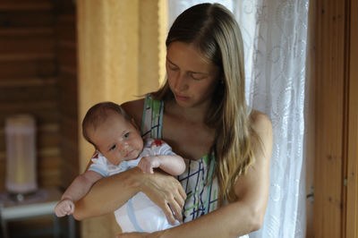 Young woman with baby at home