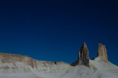 Low angle view of mountain against sky at night