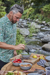 Chef prepares chimichurri from scratch at campground picnic barbecue