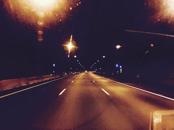 Close-up of illuminated road at night