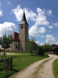 Church by building against sky