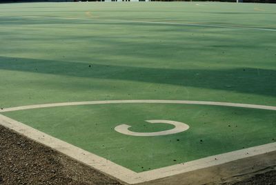 High angle view of arrow sign on grass