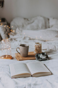 Coffee cup and book on table at home