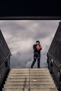 Low angle view of man standing on staircase