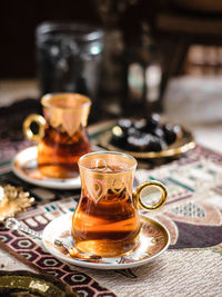 A glass of turkish tea on the table. conceptual stilllife photograhy with ramadan vibes concept