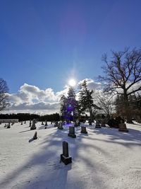 Snow covered field against sky