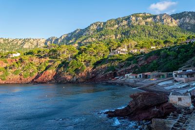 Scenic view of sea and mountains against sky