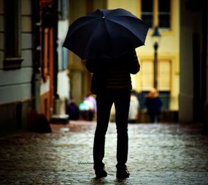 Low section of woman walking in city