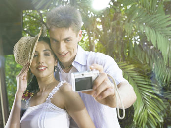 Couple taking selfie with camera