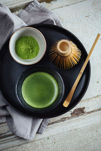 High angle view of cup of green tea on table