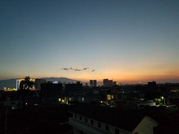 High angle view of illuminated buildings against sky during sunset