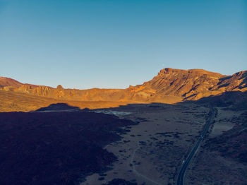 Scenic view of mountains against clear blue sky